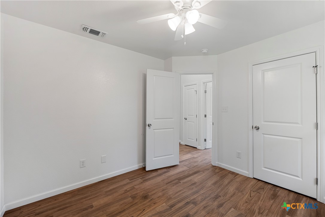 230 Plum Street Luling, TX 78648 - Photo 11 of 33 a view of an empty room with wooden floor