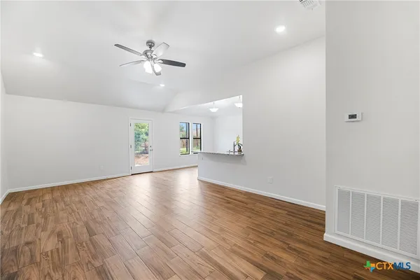 wooden floor in an empty room with a window