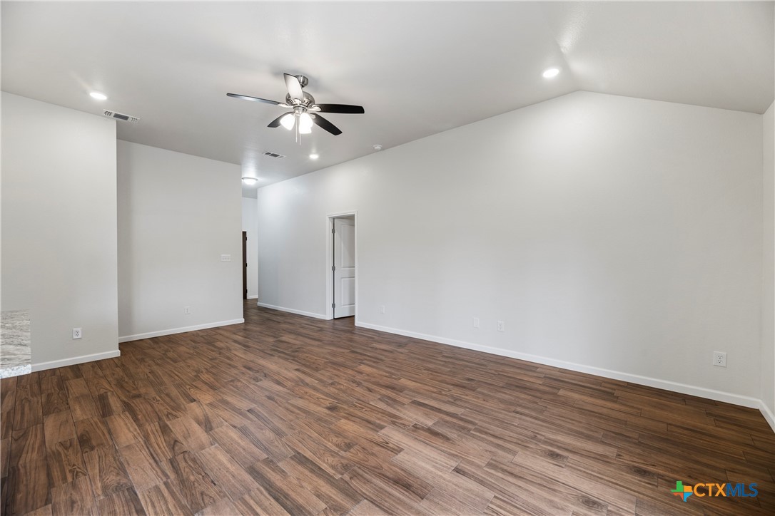 230 Plum Street Luling, TX 78648 - Photo 15 of 33 a view of an empty room and wooden floor