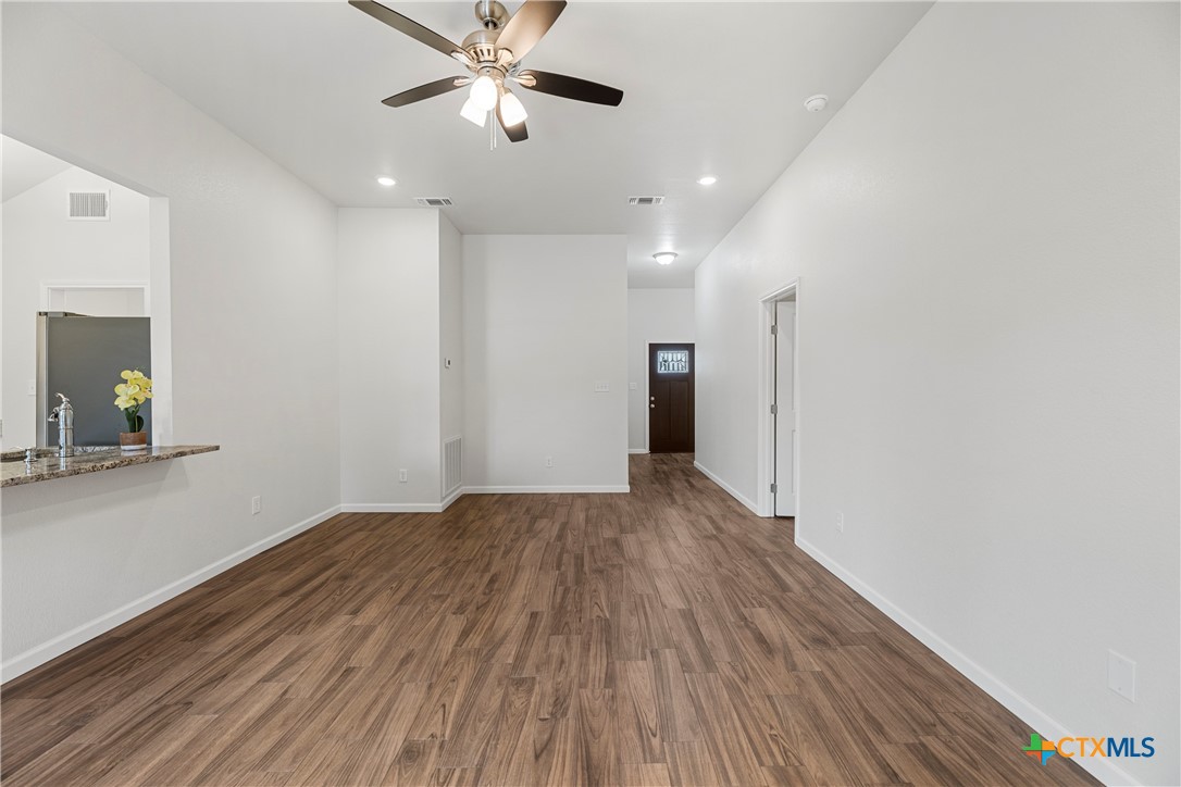 230 Plum Street Luling, TX 78648 - Photo 17 of 33 a view of empty room with wooden floor