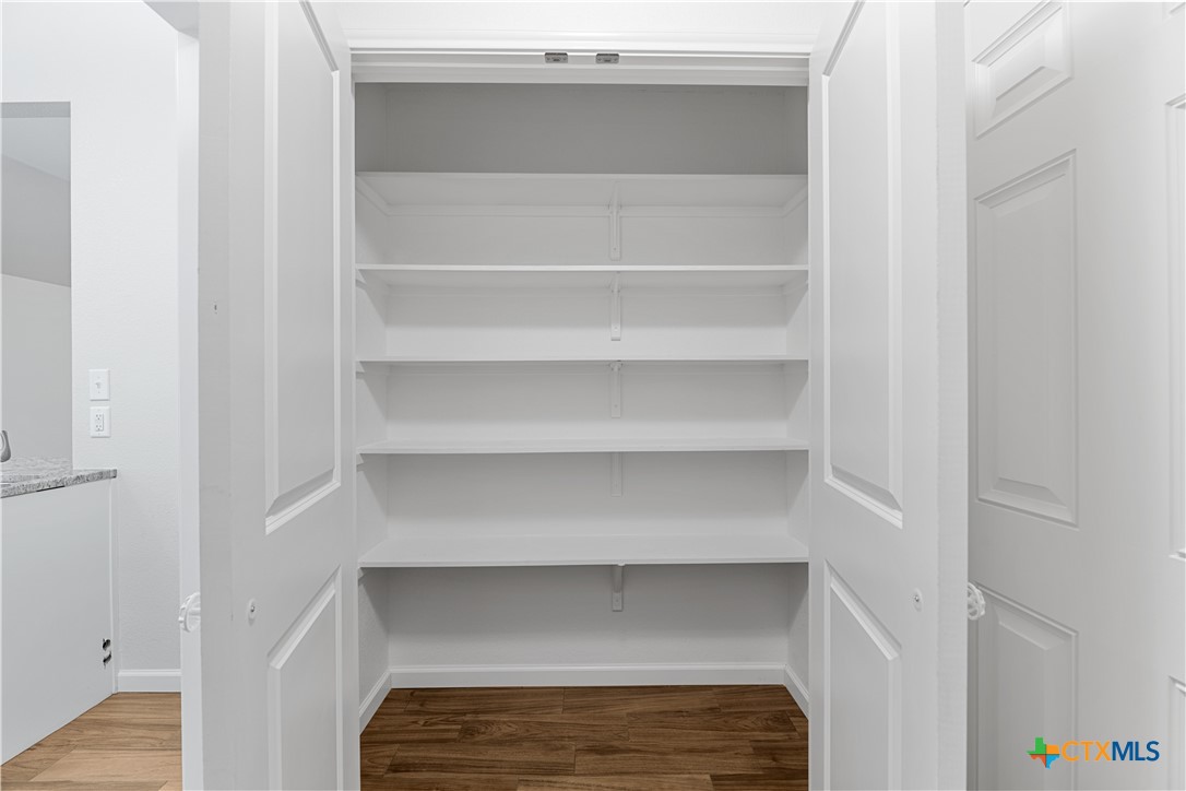 230 Plum Street Luling, TX 78648 - Photo 22 of 33 a view of walk in closet with empty racks