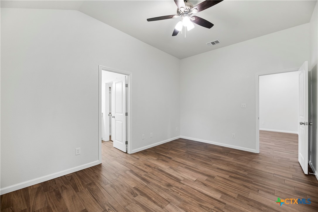 230 Plum Street Luling, TX 78648 - Photo 24 of 33 a view of an empty room with wooden floor