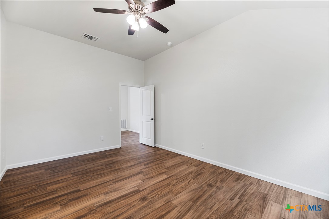 230 Plum Street Luling, TX 78648 - Photo 25 of 33 a view of an empty room with wooden floor