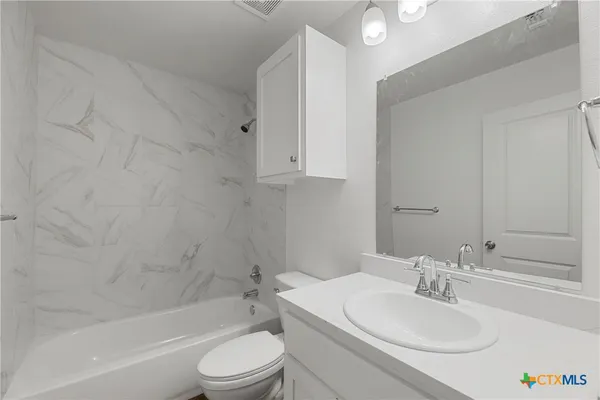 a bathroom with a sink toilet and a bathtub