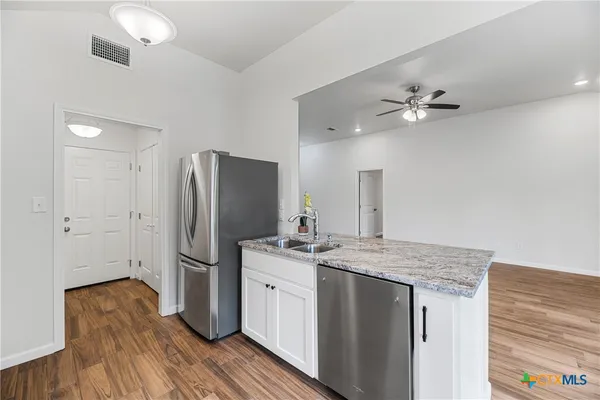 a kitchen with a refrigerator and a sink
