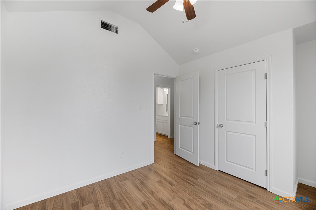 230 Plum Street Luling, TX 78648 - Photo 8 of 33 a view of an empty room with wooden floor