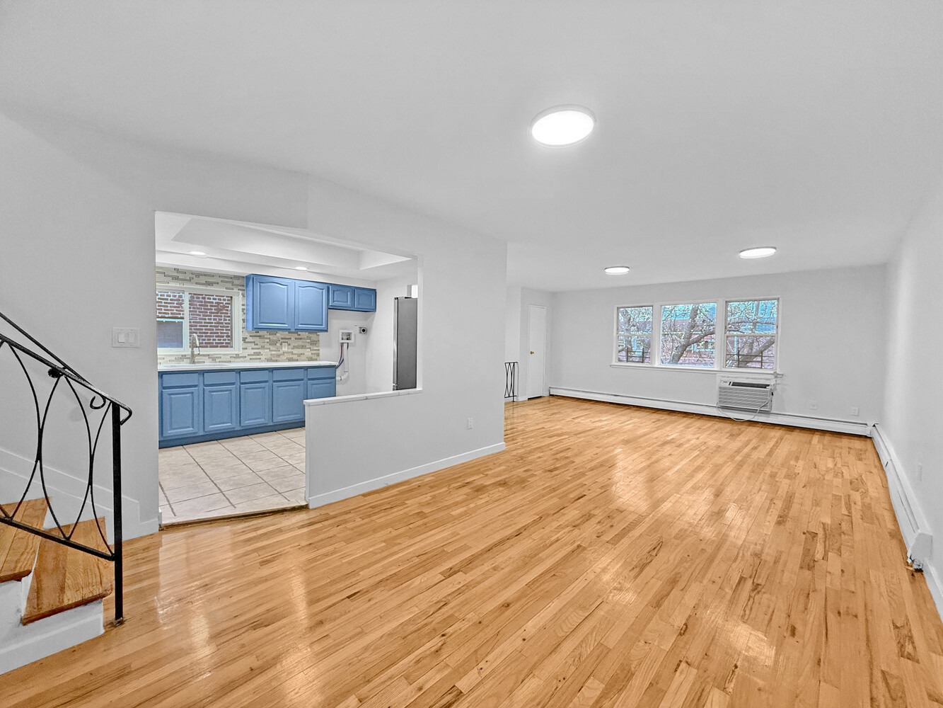 a view of a kitchen with wooden floor and a kitchen