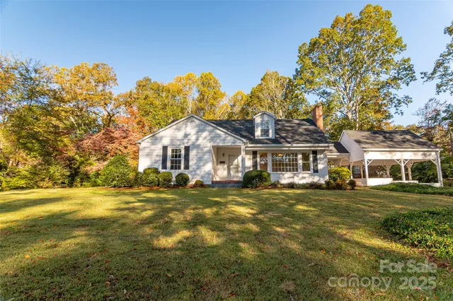 a front view of a house with a big yard