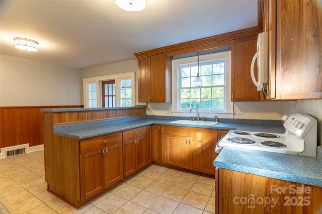 a kitchen with a sink a cabinets and window