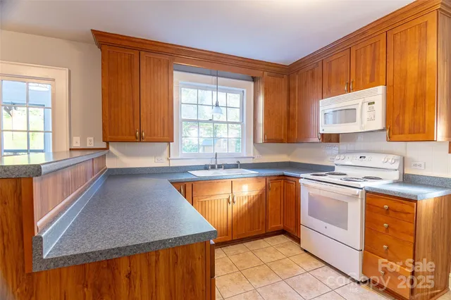a kitchen with stainless steel appliances granite countertop a sink and a stove
