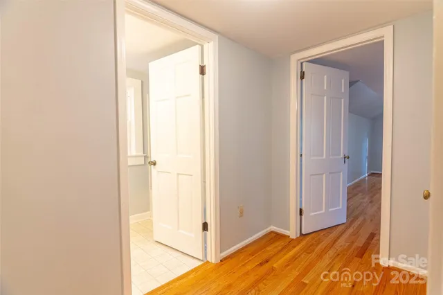 a view of a bedroom with wooden floor