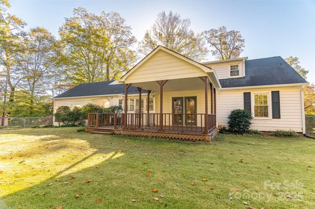 a view of a house with a yard and porch