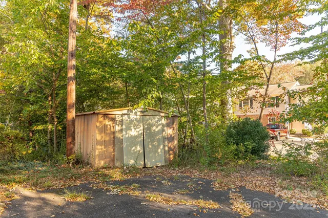 a backyard of a house with a yard and outdoor seating