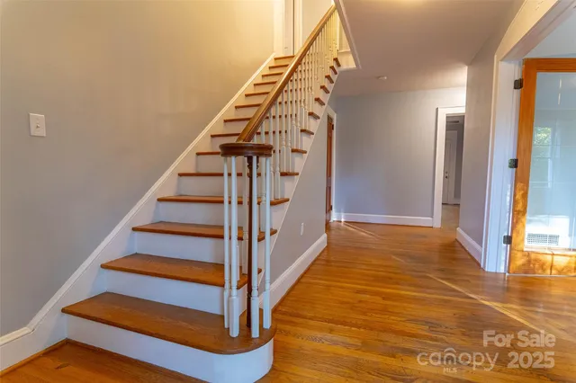 a view of entryway and hall with wooden floor