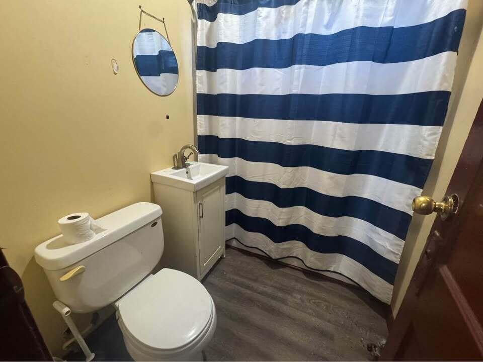 105 East 39th Avenue Gary, IN 46409 - Photo 13 of 19 a white toilet sitting next to a shower curtain