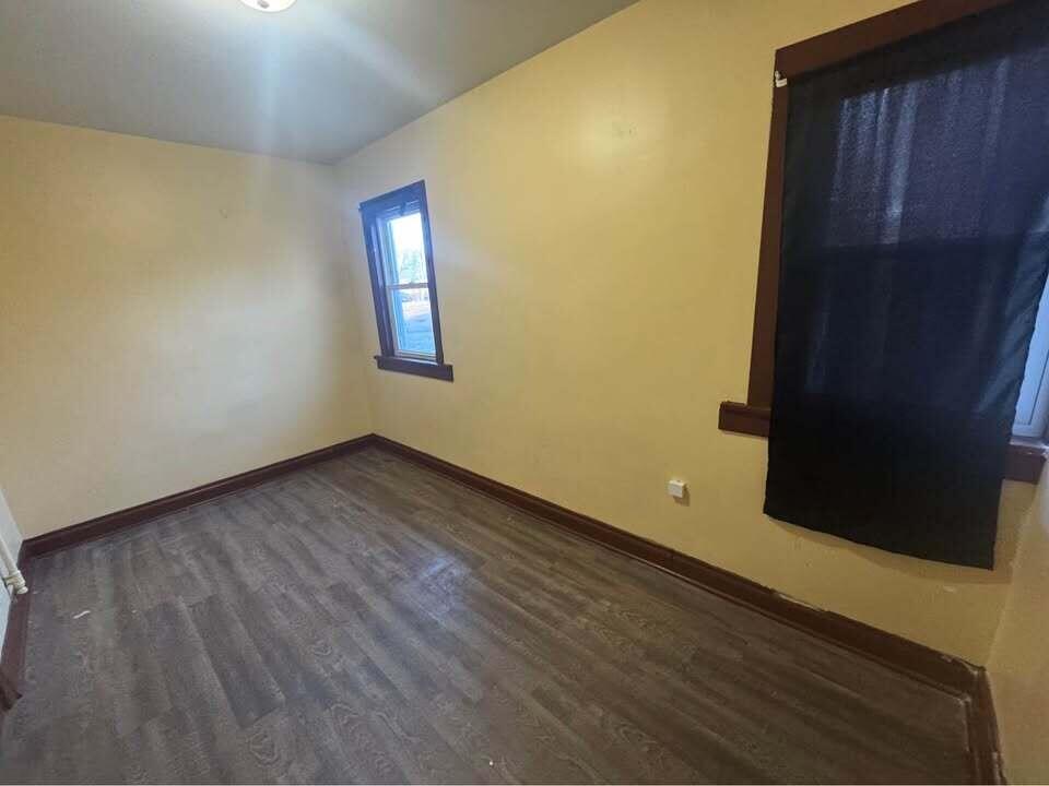 105 East 39th Avenue Gary, IN 46409 - Photo 15 of 19 a view of an empty room with wooden floor and a window