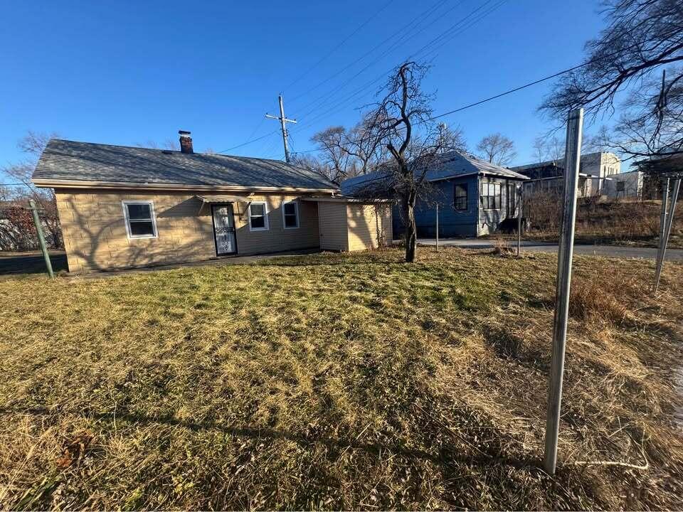 105 East 39th Avenue Gary, IN 46409 - Photo 3 of 19 a front view of a house with a yard
