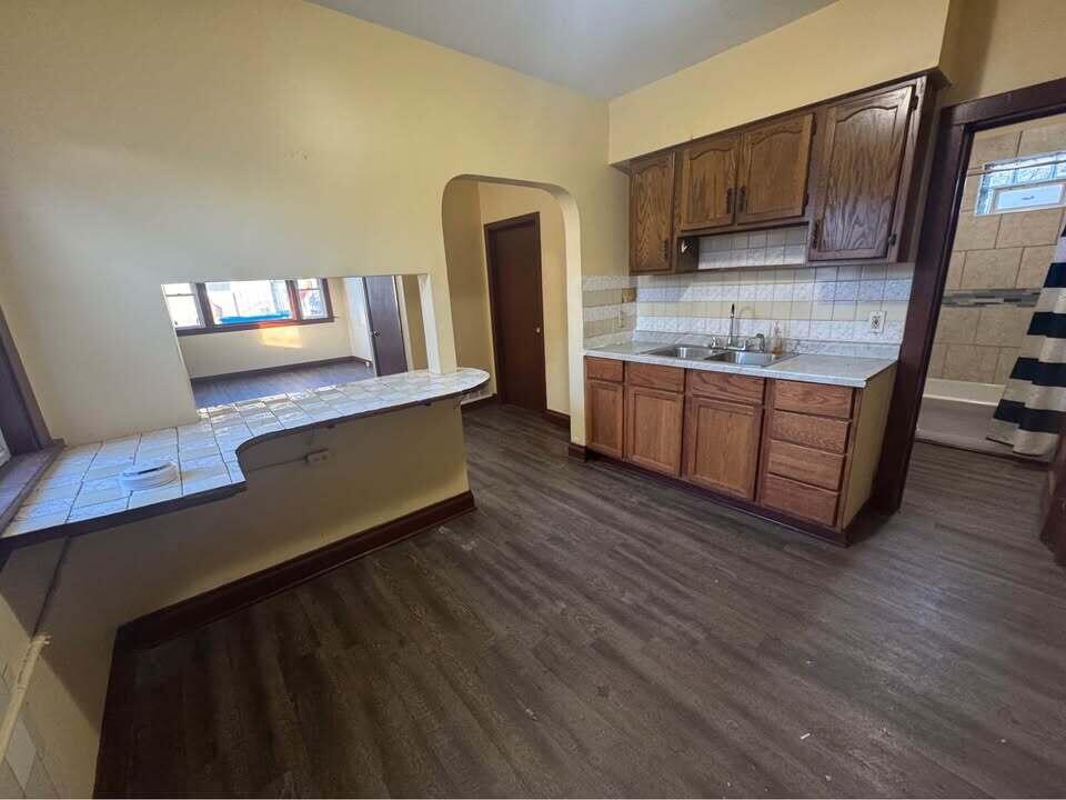 105 East 39th Avenue Gary, IN 46409 - Photo 10 of 19 a kitchen with stainless steel appliances granite countertop a refrigerator a stove and a wooden floors