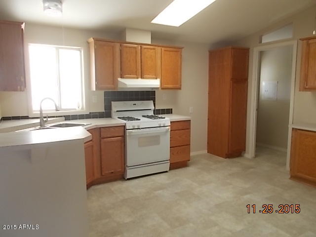 7125 West Nancy Road Peoria, AZ 85382 - Photo 16 of 39 a kitchen with a stove sink and window