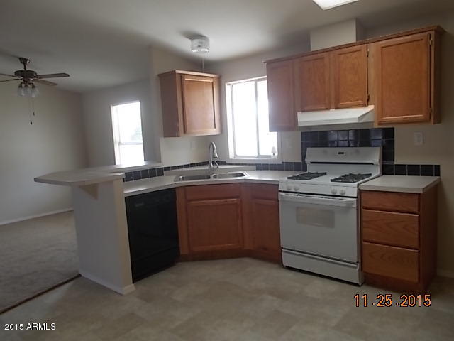 7125 West Nancy Road Peoria, AZ 85382 - Photo 17 of 39 a kitchen with a sink stove and microwave