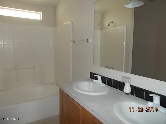 7125 West Nancy Road Peoria, AZ 85382 - Photo 28 of 39 a bathroom with a sink and a mirror