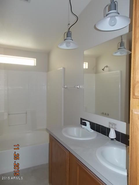 7125 West Nancy Road Peoria, AZ 85382 - Photo 29 of 39 a bathroom with a sink and a mirror