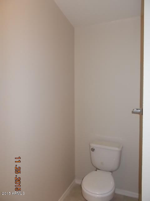 7125 West Nancy Road Peoria, AZ 85382 - Photo 31 of 39 a white toilet sitting next to a white cabinet