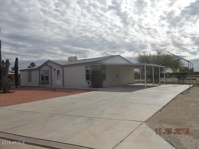 7125 West Nancy Road Peoria, AZ 85382 - Photo 36 of 39 a front view of a house with a yard and garage