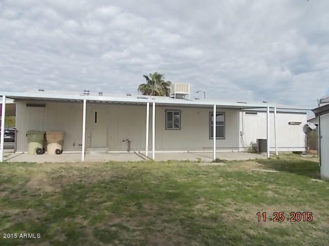7125 West Nancy Road Peoria, AZ 85382 - Photo 5 of 39 a front view of a house with a yard and garage