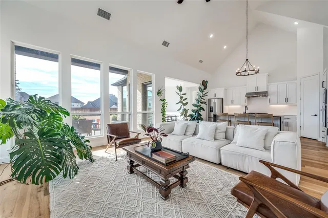 a kitchen with stainless steel appliances granite countertop a sink a stove and a wooden floors