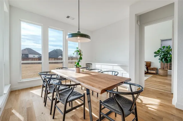 a bedroom with a large bed and a potted plant
