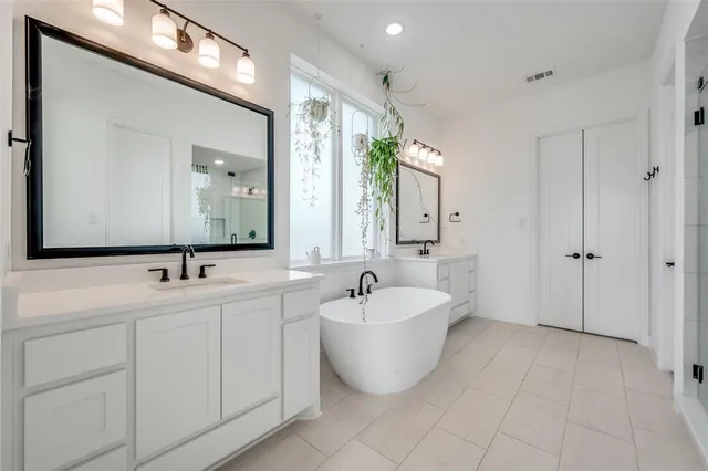 a en suite bathroom with a tub and window