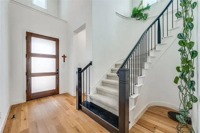 a view of entryway and hall with wooden floor