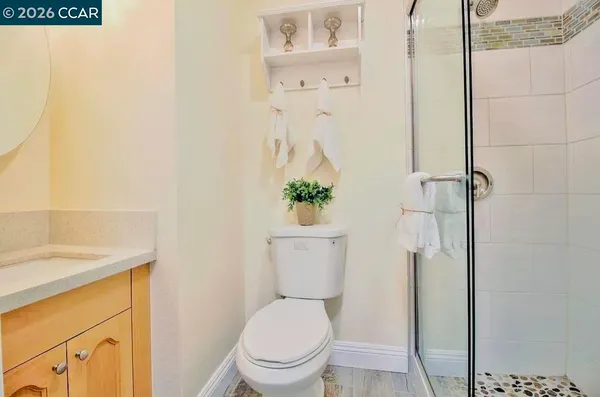 a bathroom with a toilet and a shower