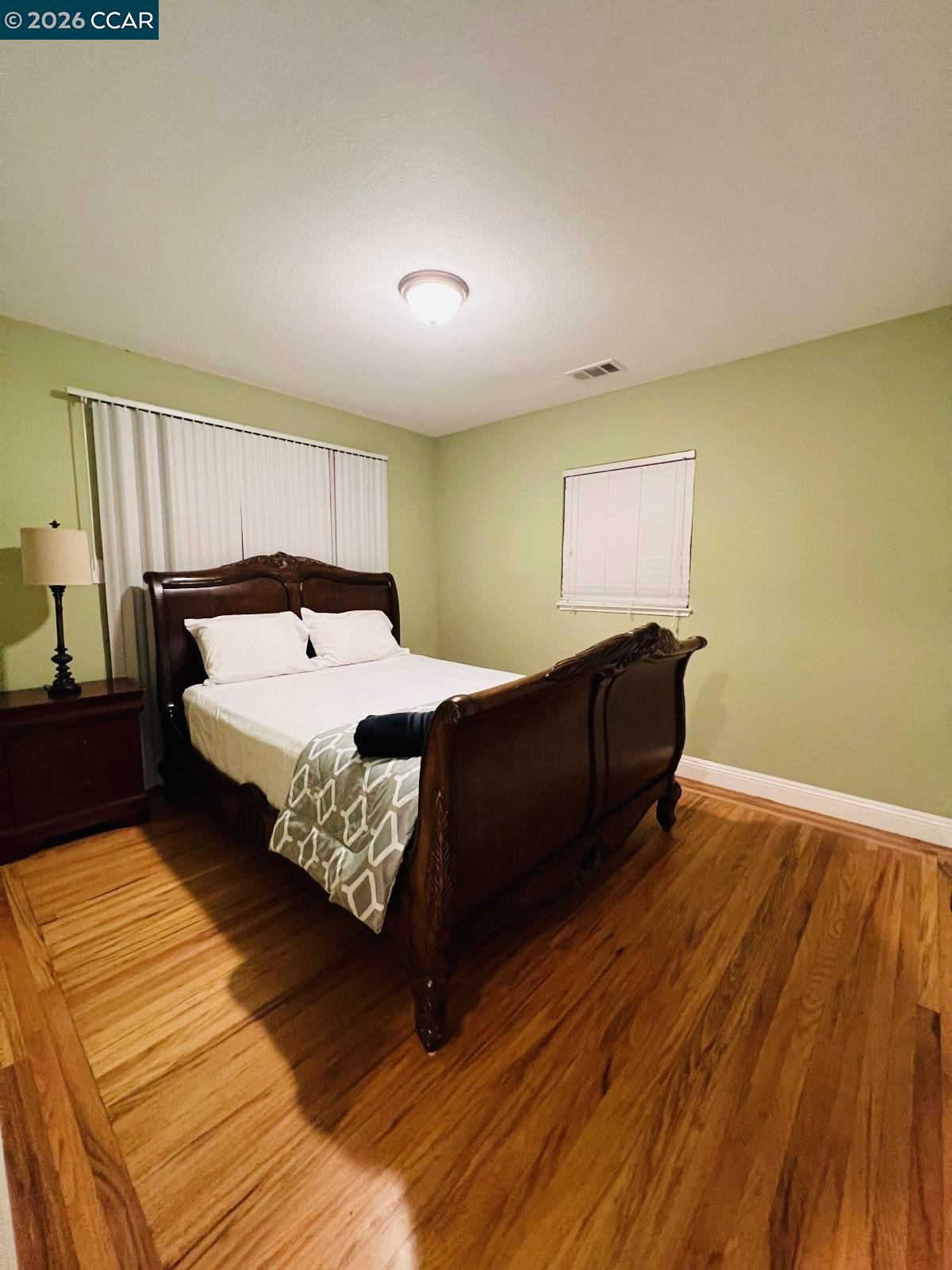 143 Pulido Road Danville, CA 94526 - Photo 20 of 27 a bedroom with a bed and wooden floor
