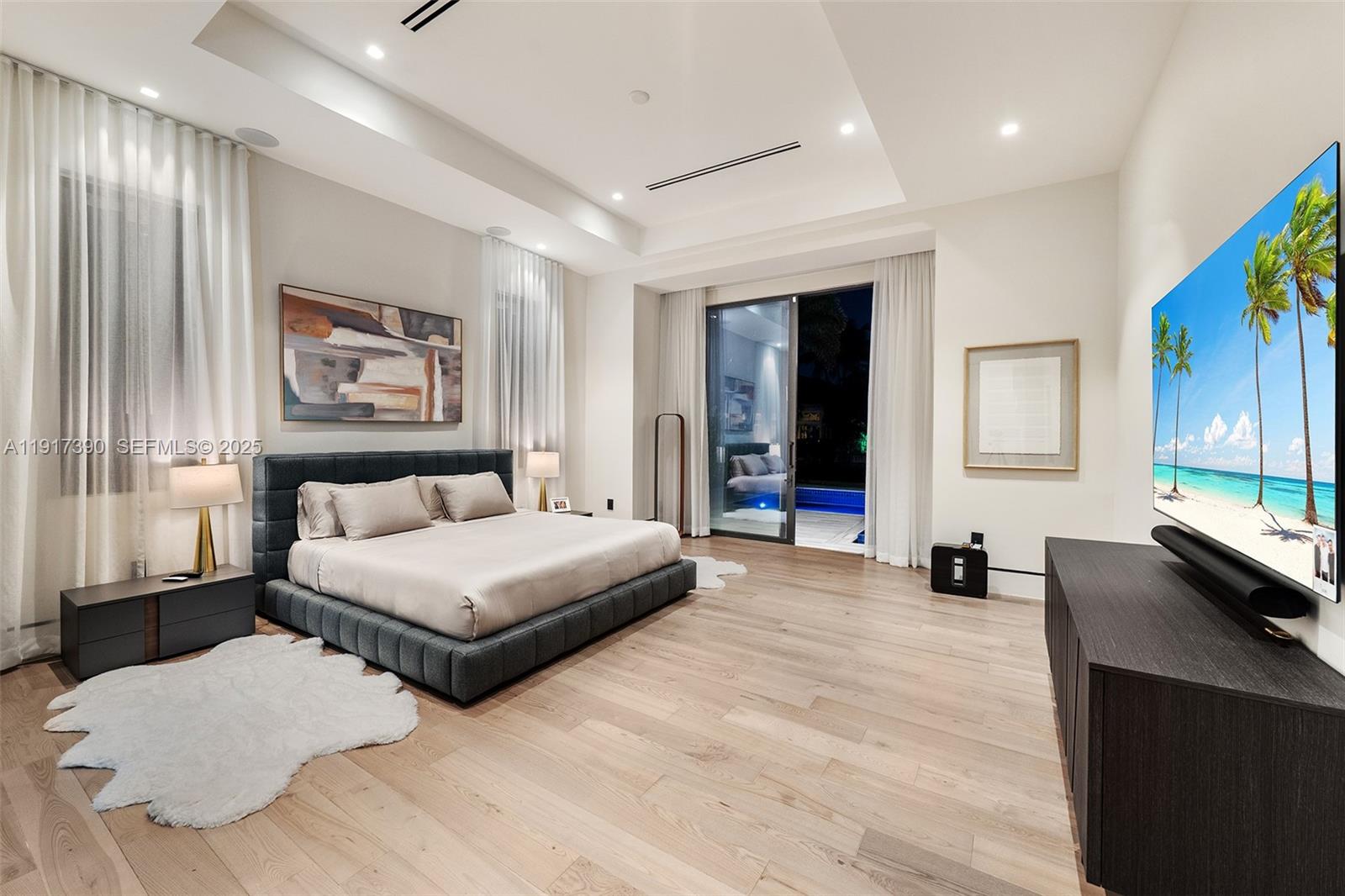900 Washington Street Hollywood, FL 33019 - Photo 38 of 61 a spacious bedroom with a large bed and a large window