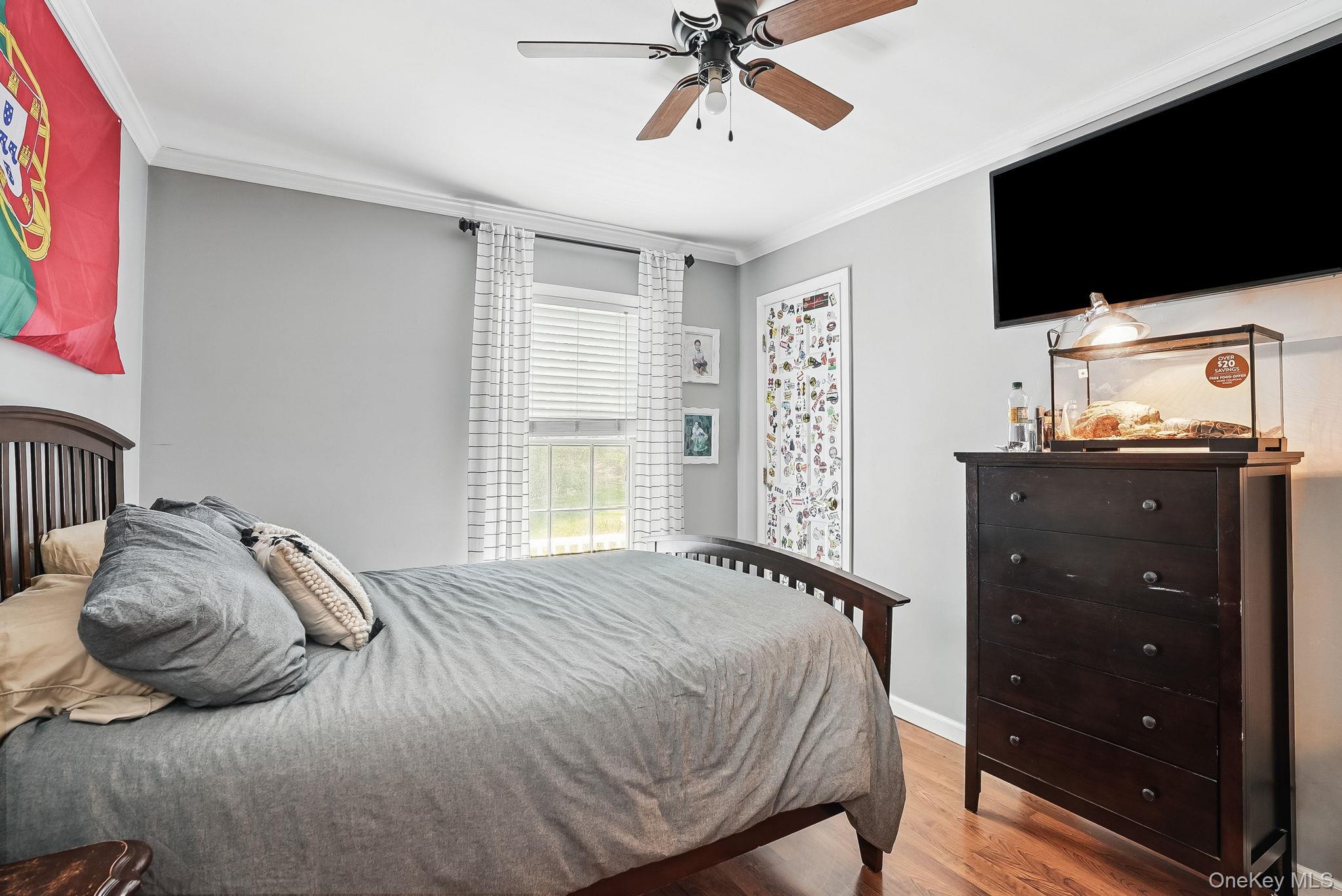 304 Church Road Putnam Valley, NY 10579 - Photo 28 of 50 Bedroom with wood finished floors, ornamental molding, a ceiling fan, and baseboards