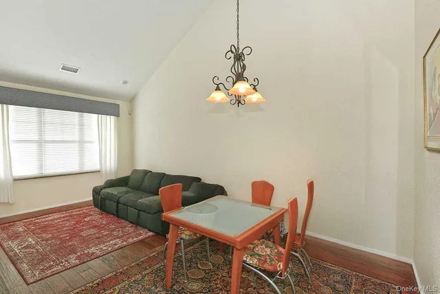 a view of a dining room with furniture and chandelier