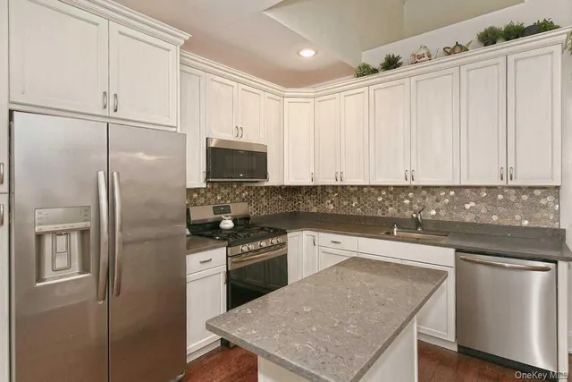 a kitchen with a refrigerator a sink and cabinets