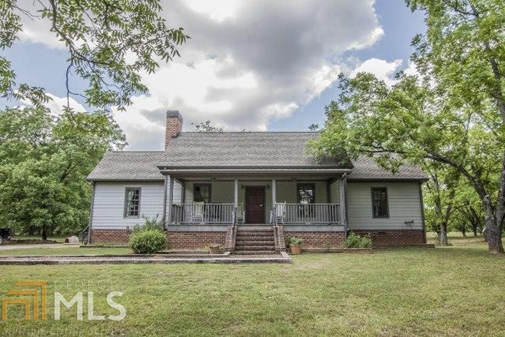 1261 Lundburg Road Washington, GA 30673 - Photo 1 of 1 a front view of a house with a garden