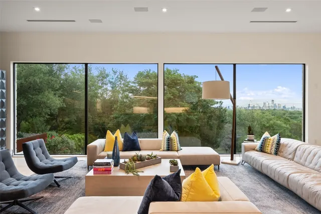 a living room with patio furniture and a floor to ceiling window