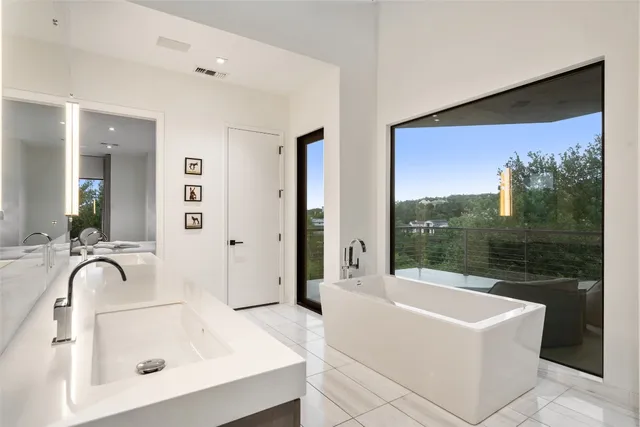 a bathroom with a tub sink and mirror