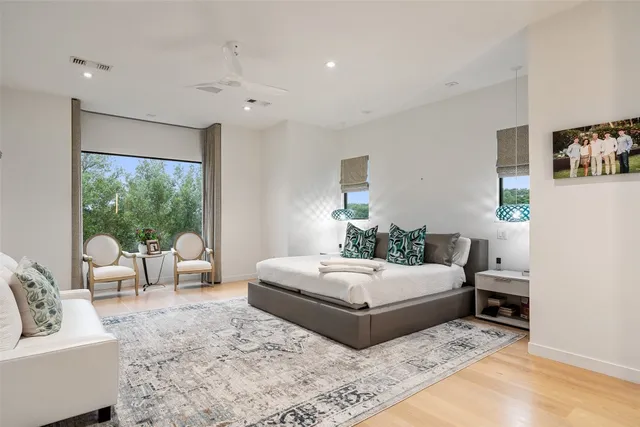 a bedroom with a large bed and a couch