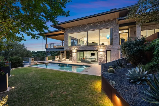 a view of a house with swimming pool and sitting area
