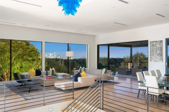 a living room with patio furniture and a floor to ceiling window