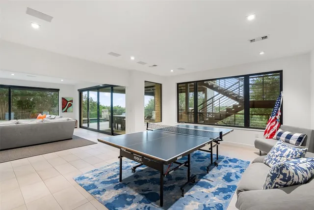 a living room with furniture and a floor to ceiling window