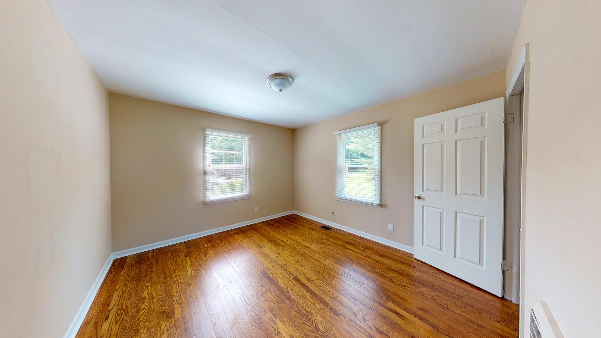 1236 Butler Bridge Road Portland, TN 37148 - Photo 16 of 22 an empty room with wooden floor and windows