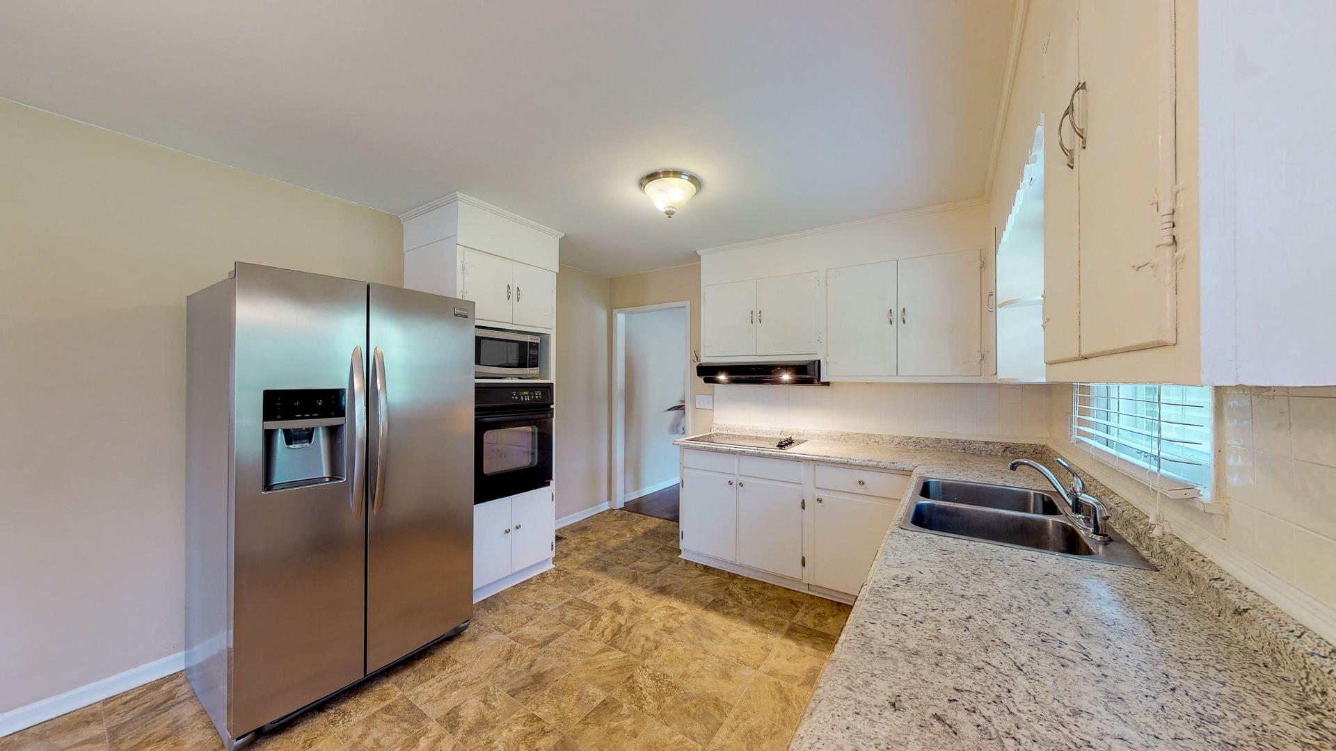 1236 Butler Bridge Road Portland, TN 37148 - Photo 5 of 22 a kitchen with a sink refrigerator and microwave
