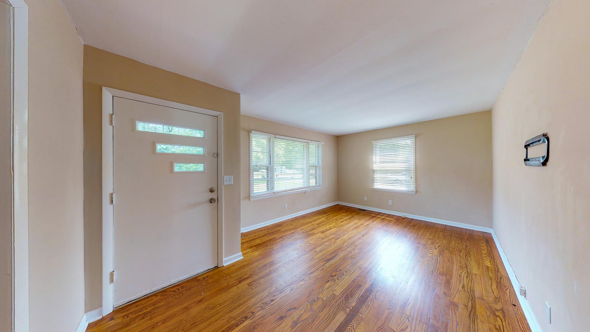 1236 Butler Bridge Road Portland, TN 37148 - Photo 6 of 22 a view of an empty room with wooden floor and a window
