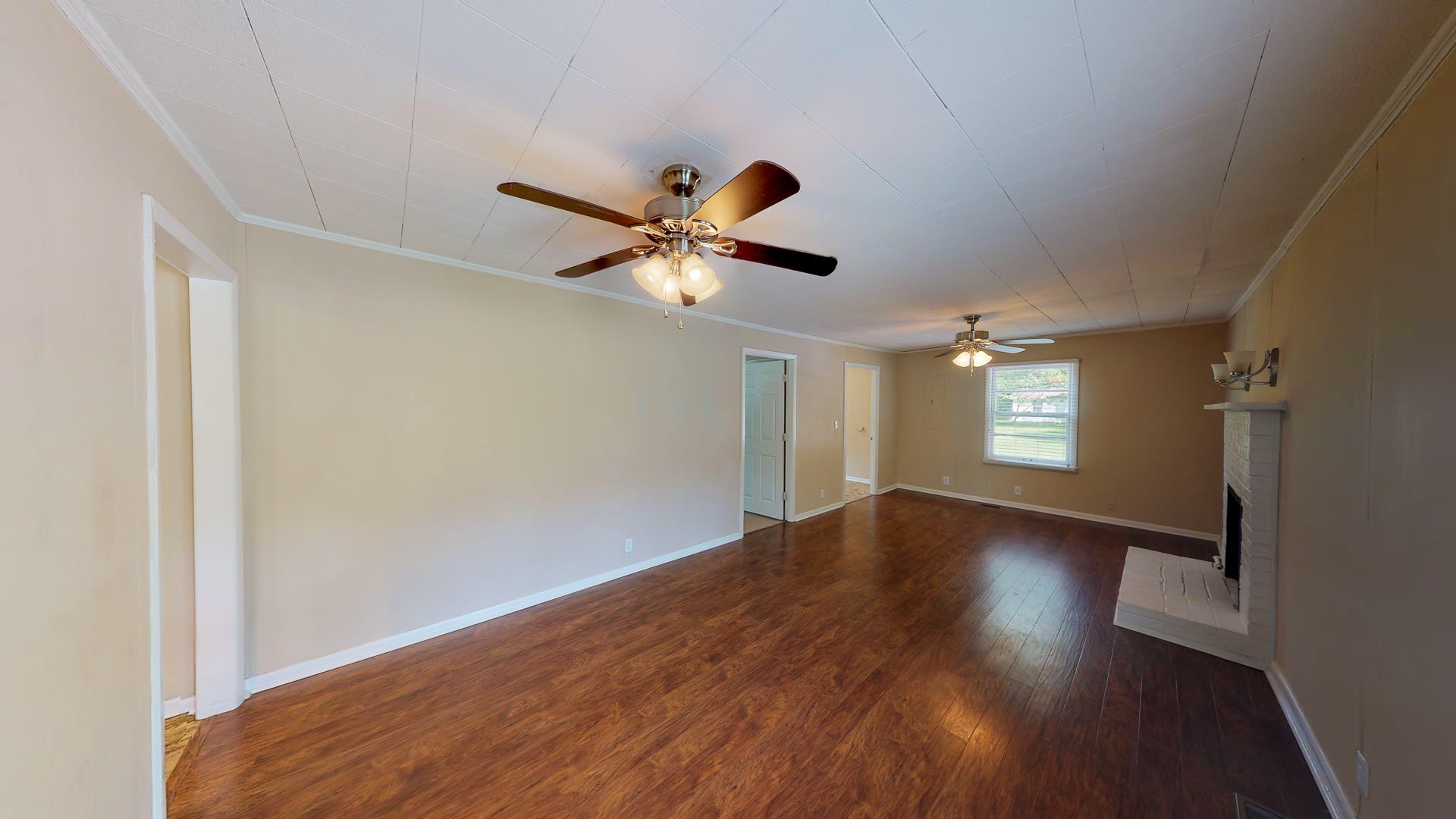 1236 Butler Bridge Road Portland, TN 37148 - Photo 8 of 22 an empty room with wooden floor and windows
